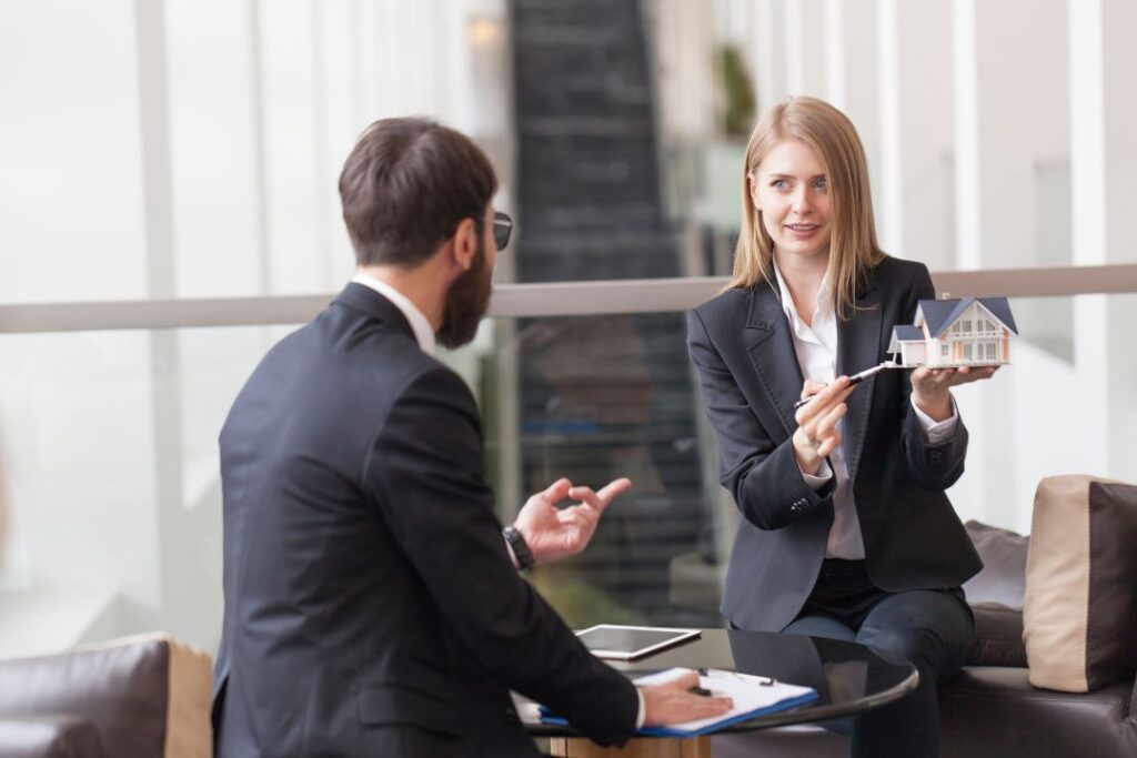 Real estate broker discussing an architectural model